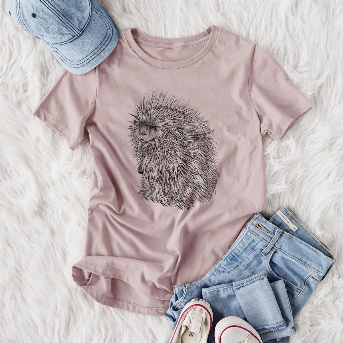 Women's relaxed fit cotton t-shirt printed with a detailed black ink illustration of a porcupine with its quills raised, styled flat on a white faux fur rug with jeans.