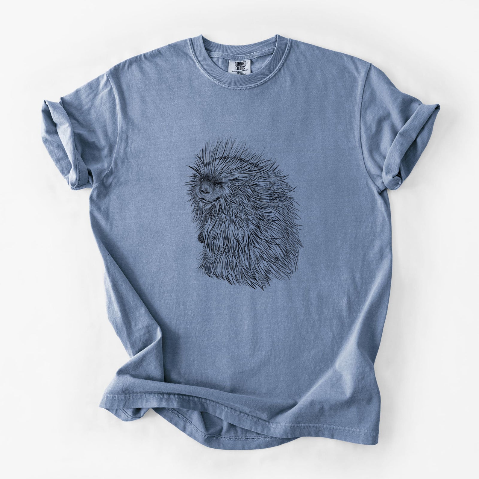 Blue jean Comfort Colors t-shirt laid flat, printed with a detailed black ink illustration of a porcupine with its quills raised.
