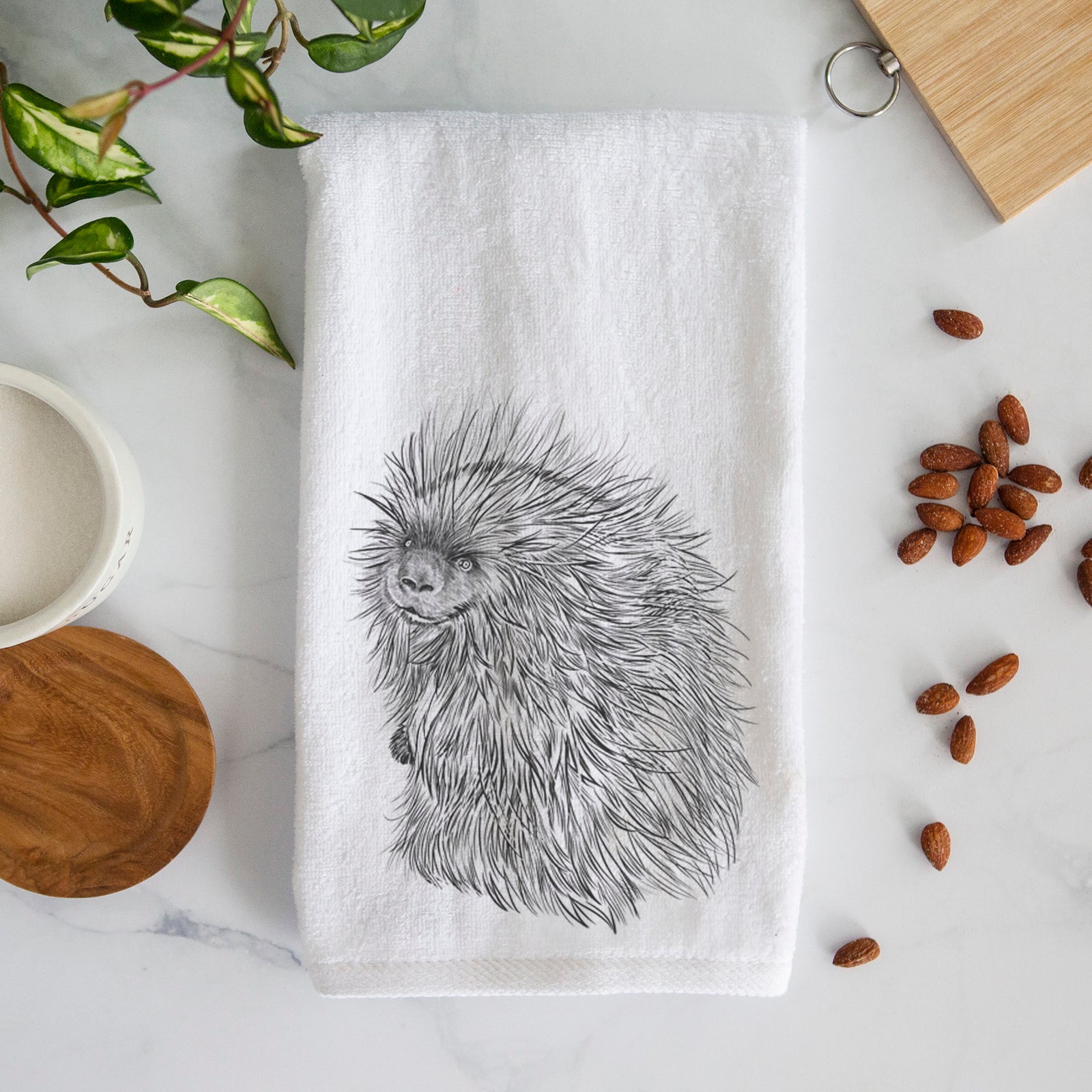 White hand towel printed with a detailed black ink illustration of a porcupine with its quills raised.