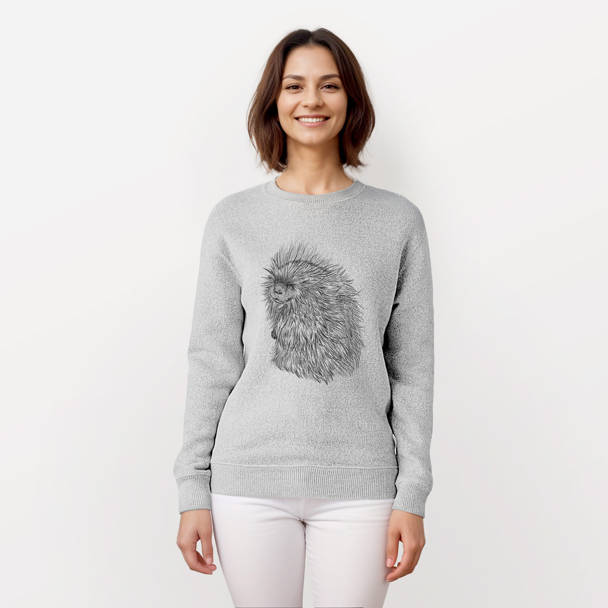 Woman wearing a knit sweatshirt printed with a detailed black ink illustration of a porcupine with its quills raised.
