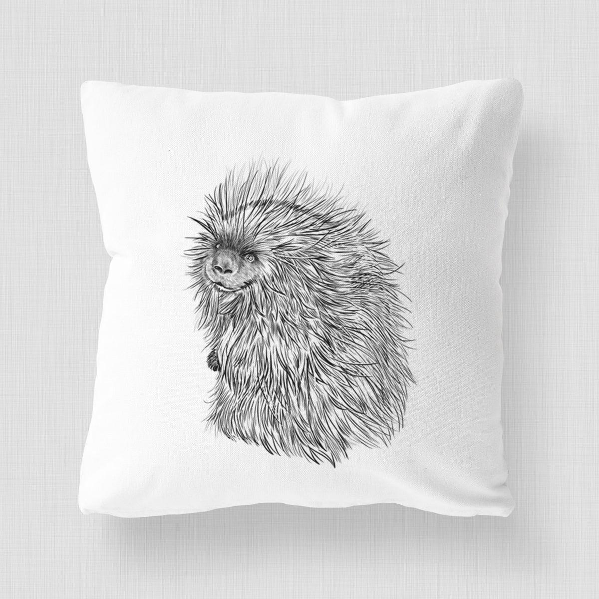 White pillow cover printed with a detailed black ink illustration of a porcupine with its quills raised.