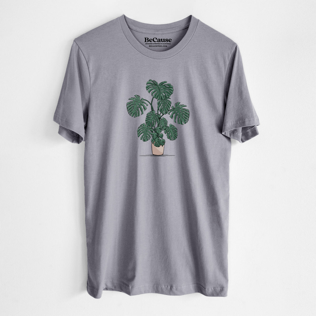 Storm grey lightweight cotton t-shirt laid flat, printed with a full-color illustration of a large potted Monstera plant.