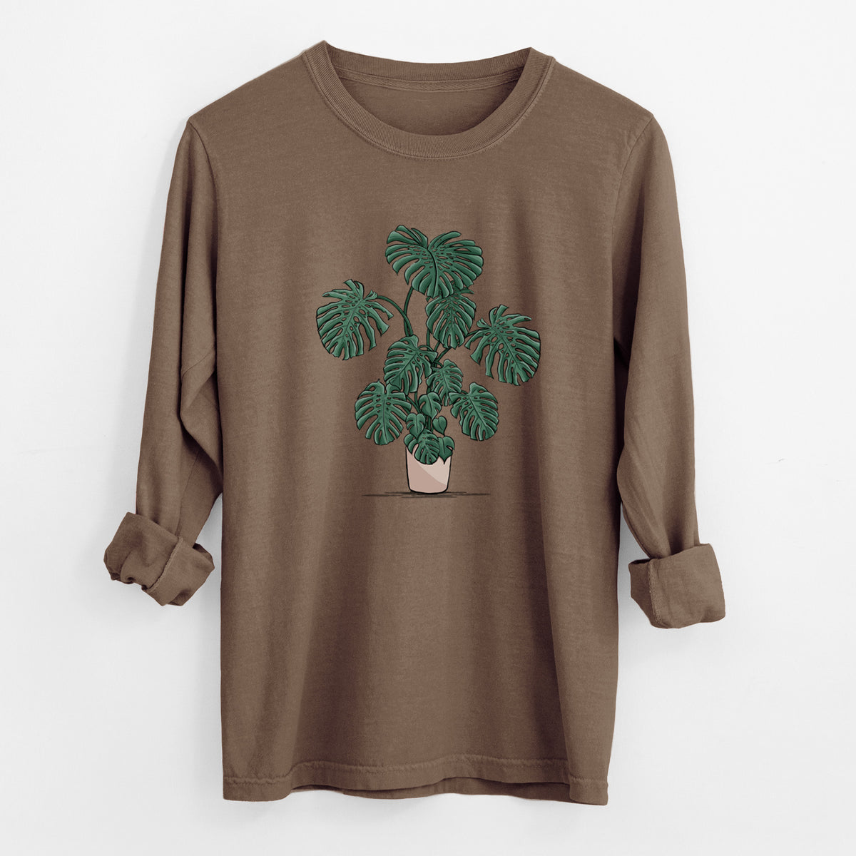Espresso brown Comfort Colors long sleeve shirt laid flat with the cuffs rolled, printed with a full-color illustration of a large potted Monstera plant.