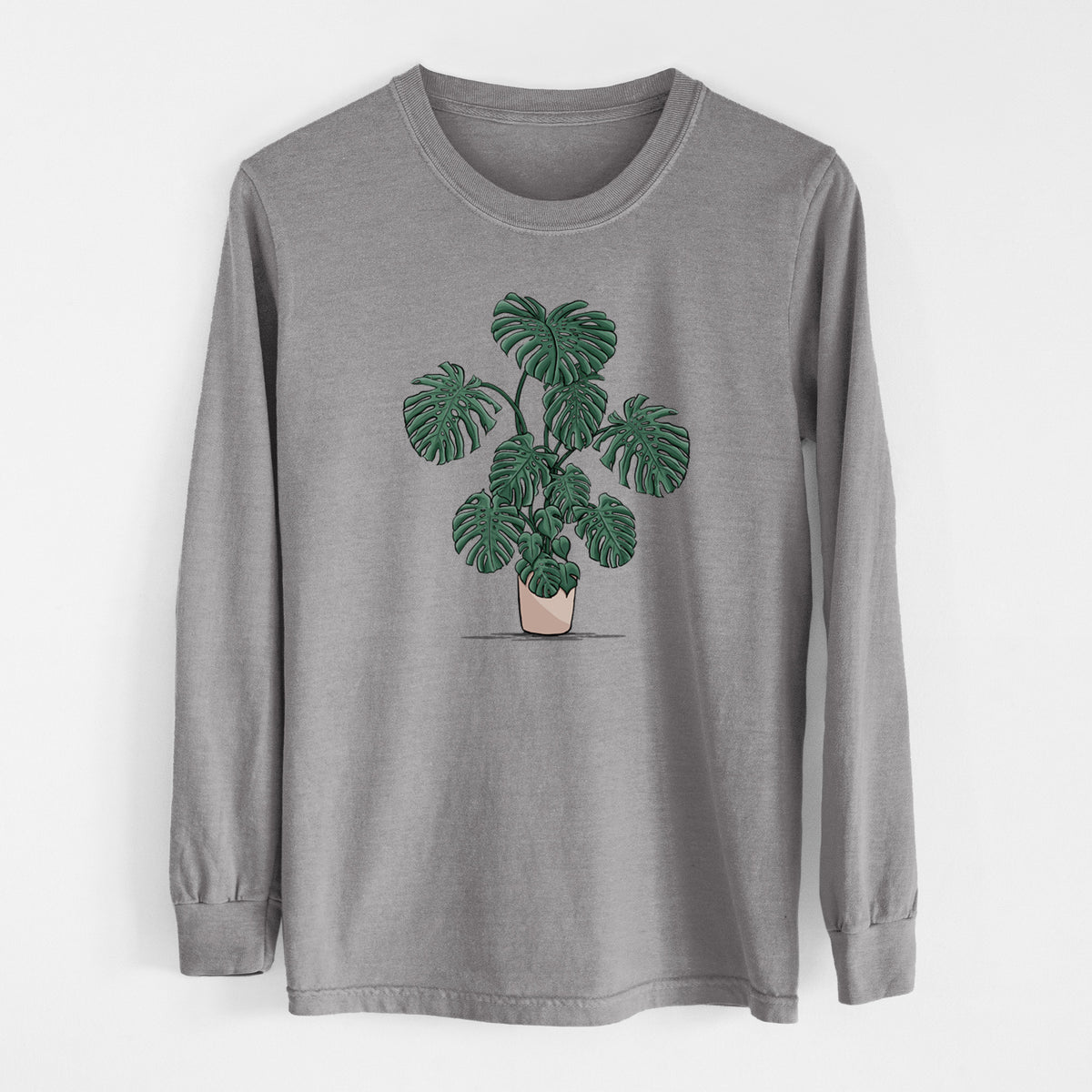 Grey Comfort Colors long sleeve shirt laid flat, printed with a full-color illustration of a large potted Monstera plant.