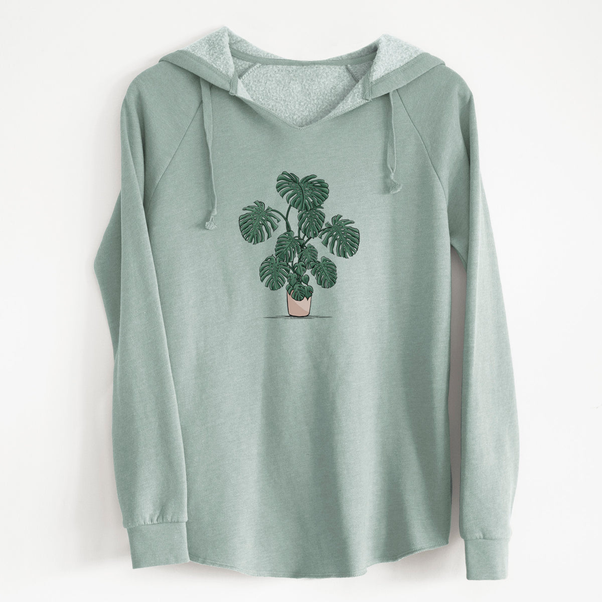 Sage green women's Cali Wave hooded sweatshirt laid flat, printed with a full-color illustration of a large potted Monstera plant.