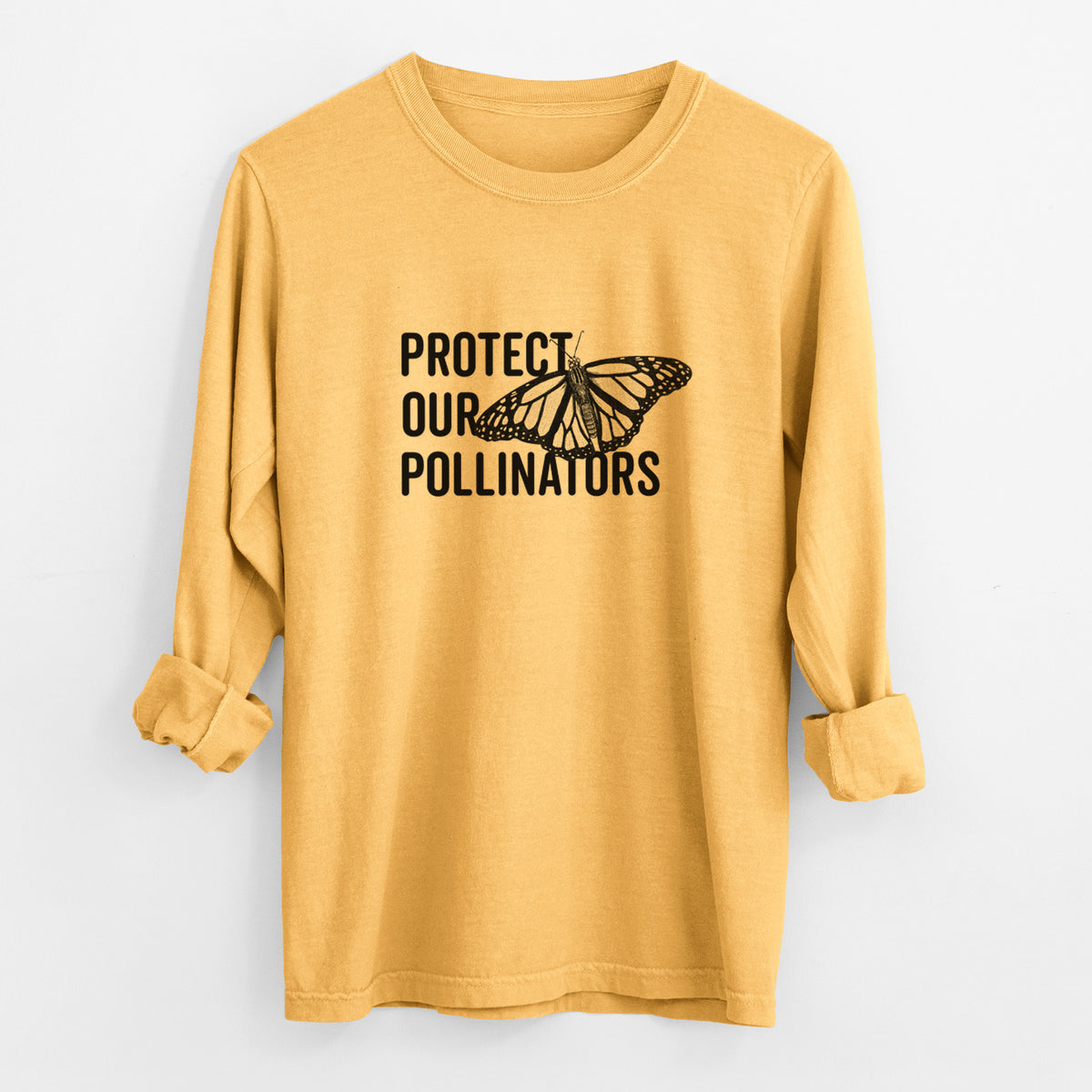 Golden wheat yellow Comfort Colors long sleeve shirt laid flat with the cuffs rolled, printed with bold black words reading Protect Our Pollinators beside a monarch butterfly.
