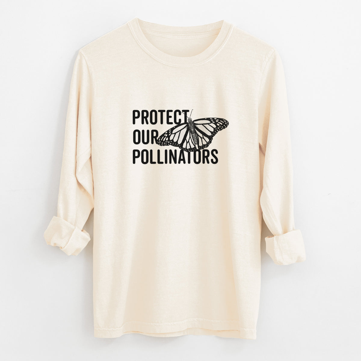 Ivory Comfort Colors long sleeve shirt laid flat with the cuffs rolled, printed with bold black words reading Protect Our Pollinators beside a monarch butterfly.