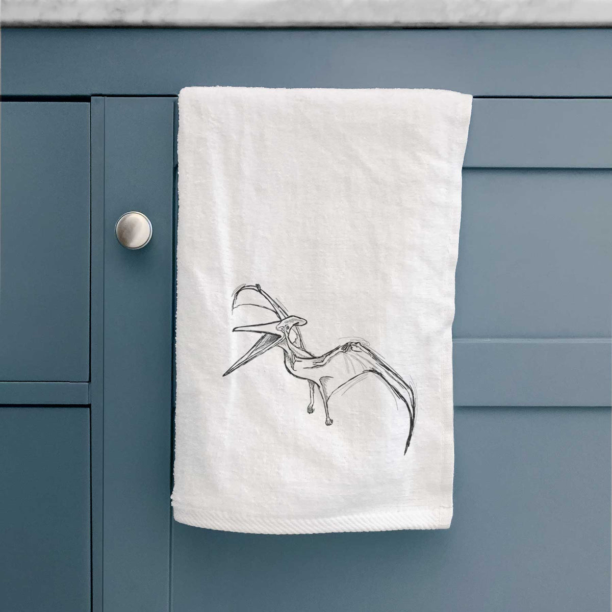 White hand towel printed with a black ink illustration of a Pteranodon in flight.