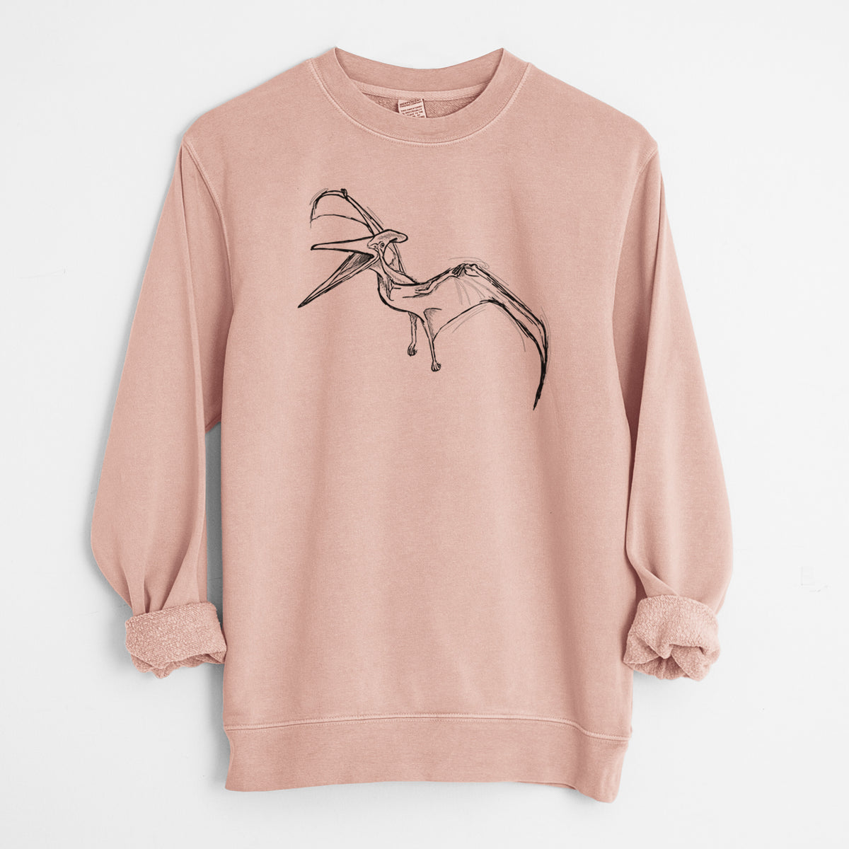 Dusty pink pigment dyed crewneck sweatshirt laid flat with the sleeves rolled, printed with a black ink illustration of a Pteranodon in flight.