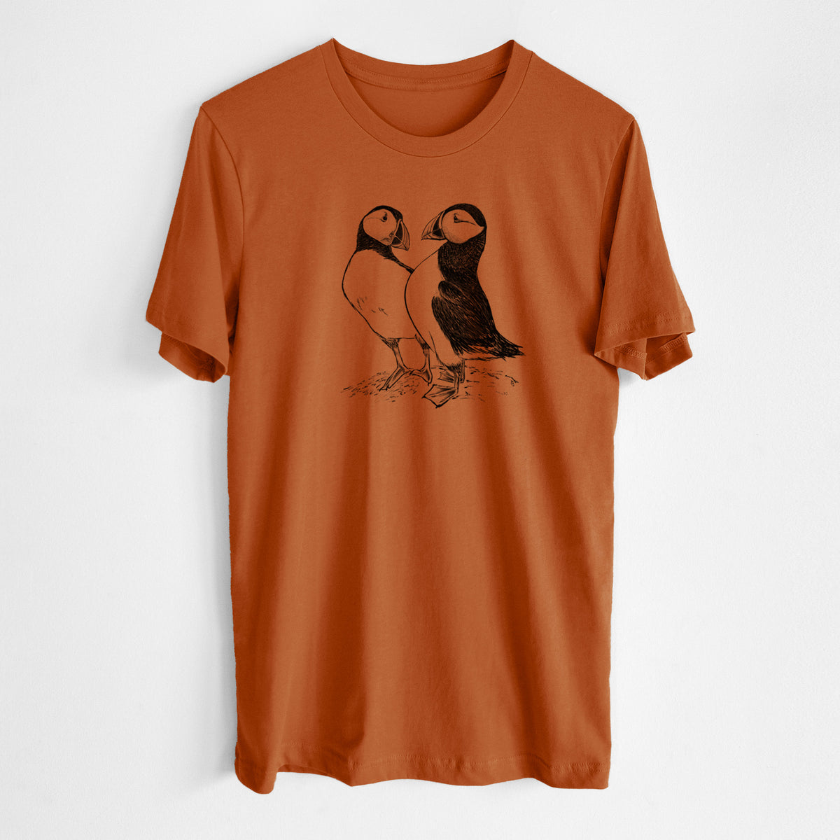 Autumn lightweight cotton t-shirt laid flat, printed with a detailed black ink illustration of two Atlantic puffins standing side by side.