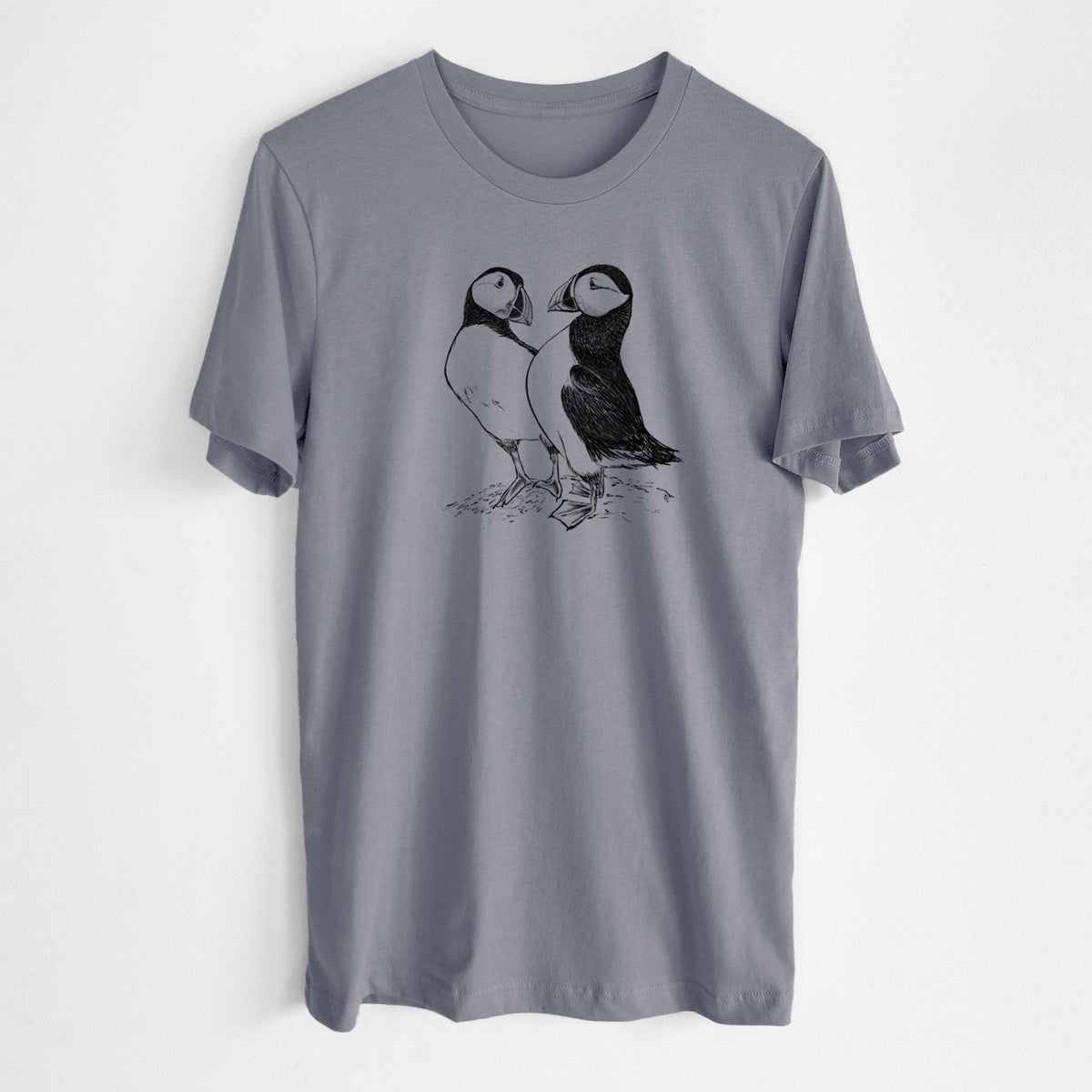 Storm grey lightweight cotton t-shirt laid flat, printed with a detailed black ink illustration of two Atlantic puffins standing side by side.