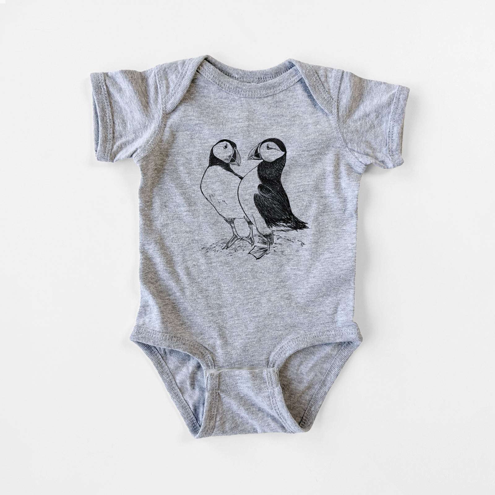 Grey baby bodysuit laid flat, printed with a detailed black ink illustration of two Atlantic puffins standing side by side.