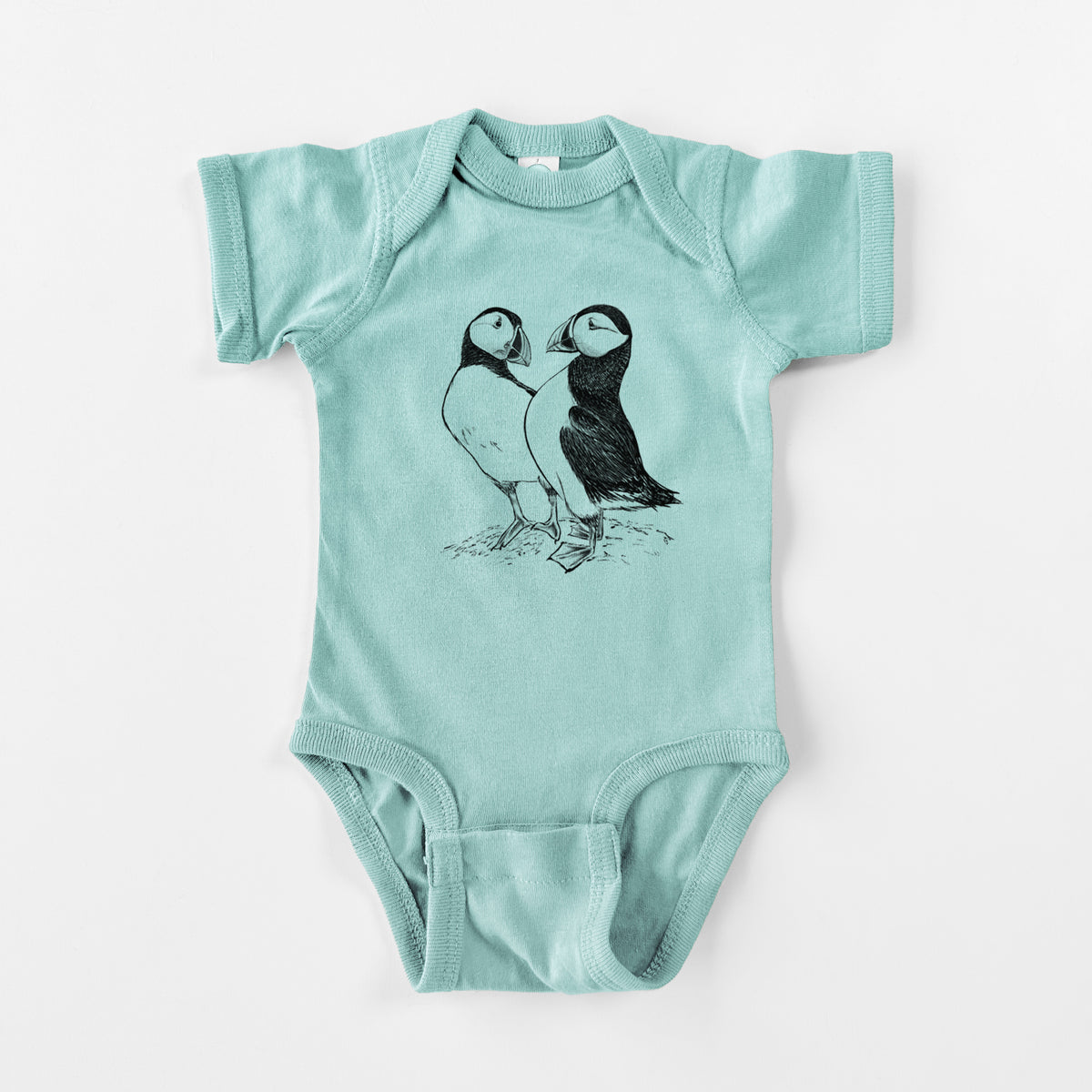 Saltwater baby bodysuit laid flat, printed with a detailed black ink illustration of two Atlantic puffins standing side by side.