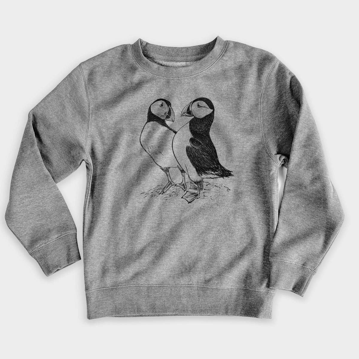 Nickel grey youth crewneck sweatshirt laid flat, printed with a detailed black ink illustration of two Atlantic puffins standing side by side.