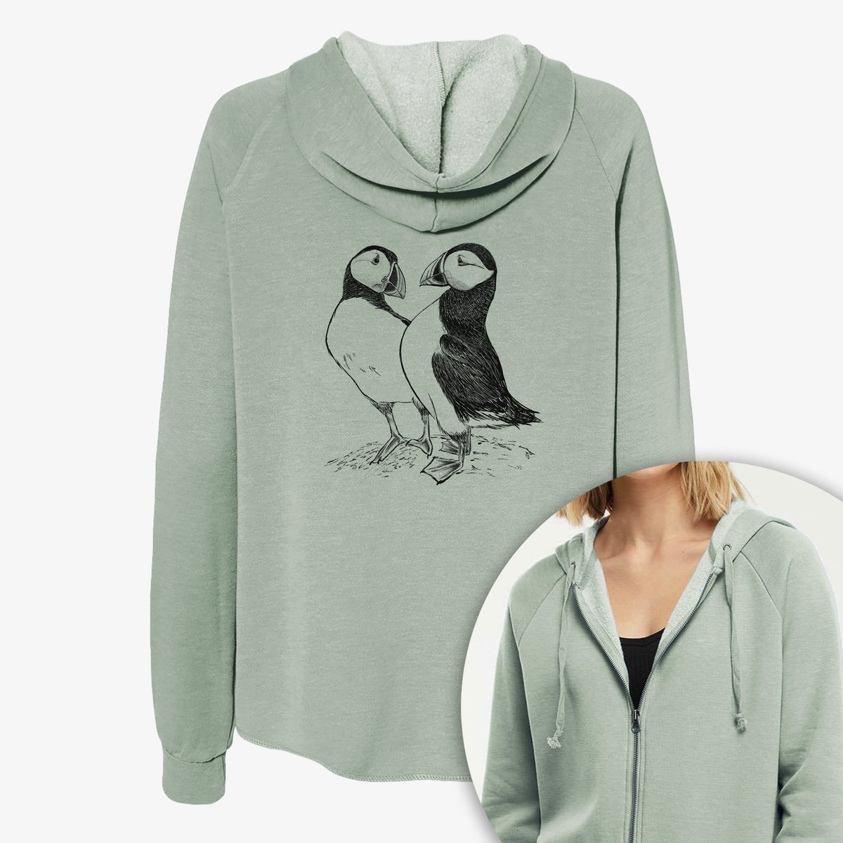 Women's Cali Wave zip-up sweatshirt printed with a detailed black ink illustration of two Atlantic puffins standing side by side, with a close-up of the zipper.