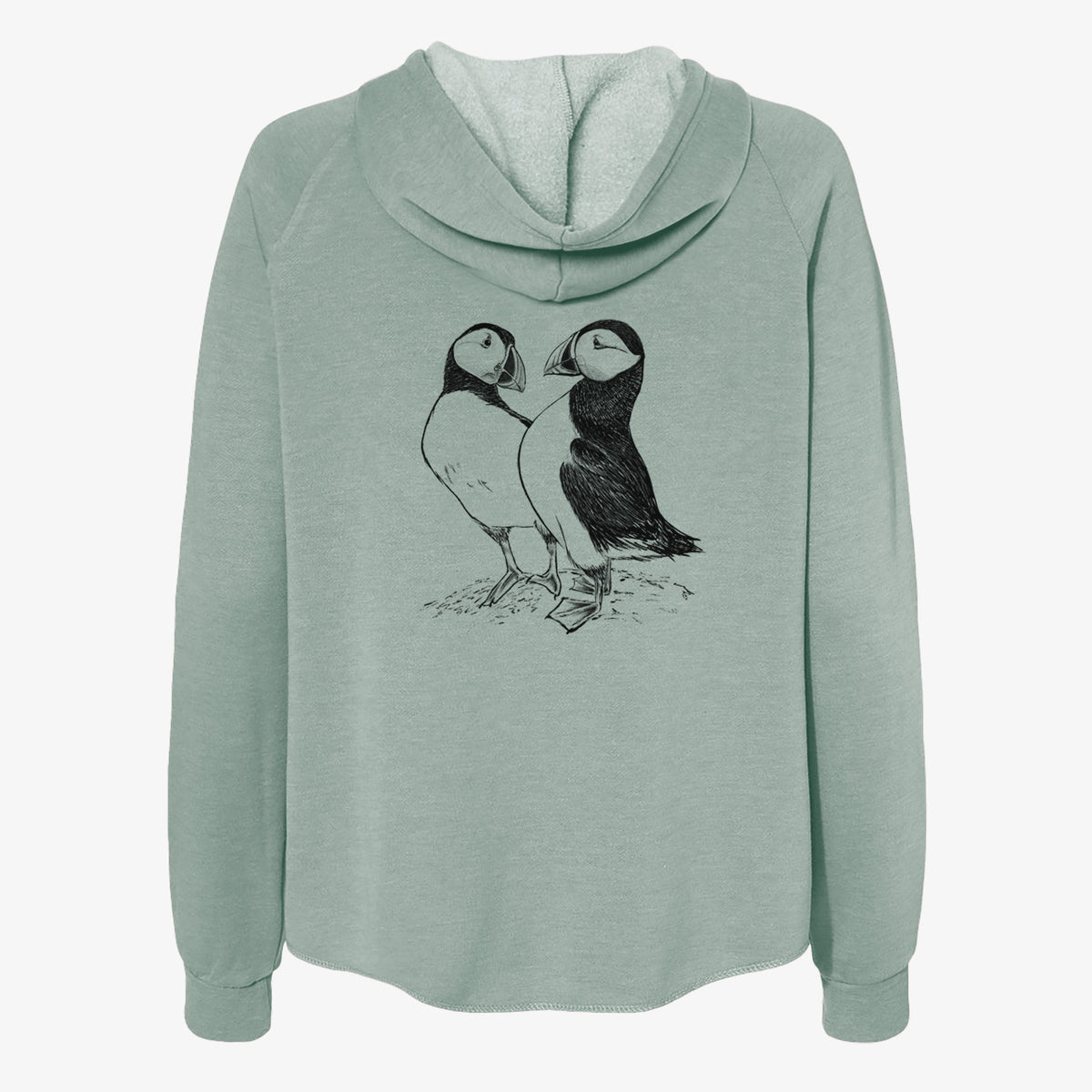 Sage green women's Cali Wave zip-up sweatshirt laid flat, printed with a detailed black ink illustration of two Atlantic puffins standing side by side.