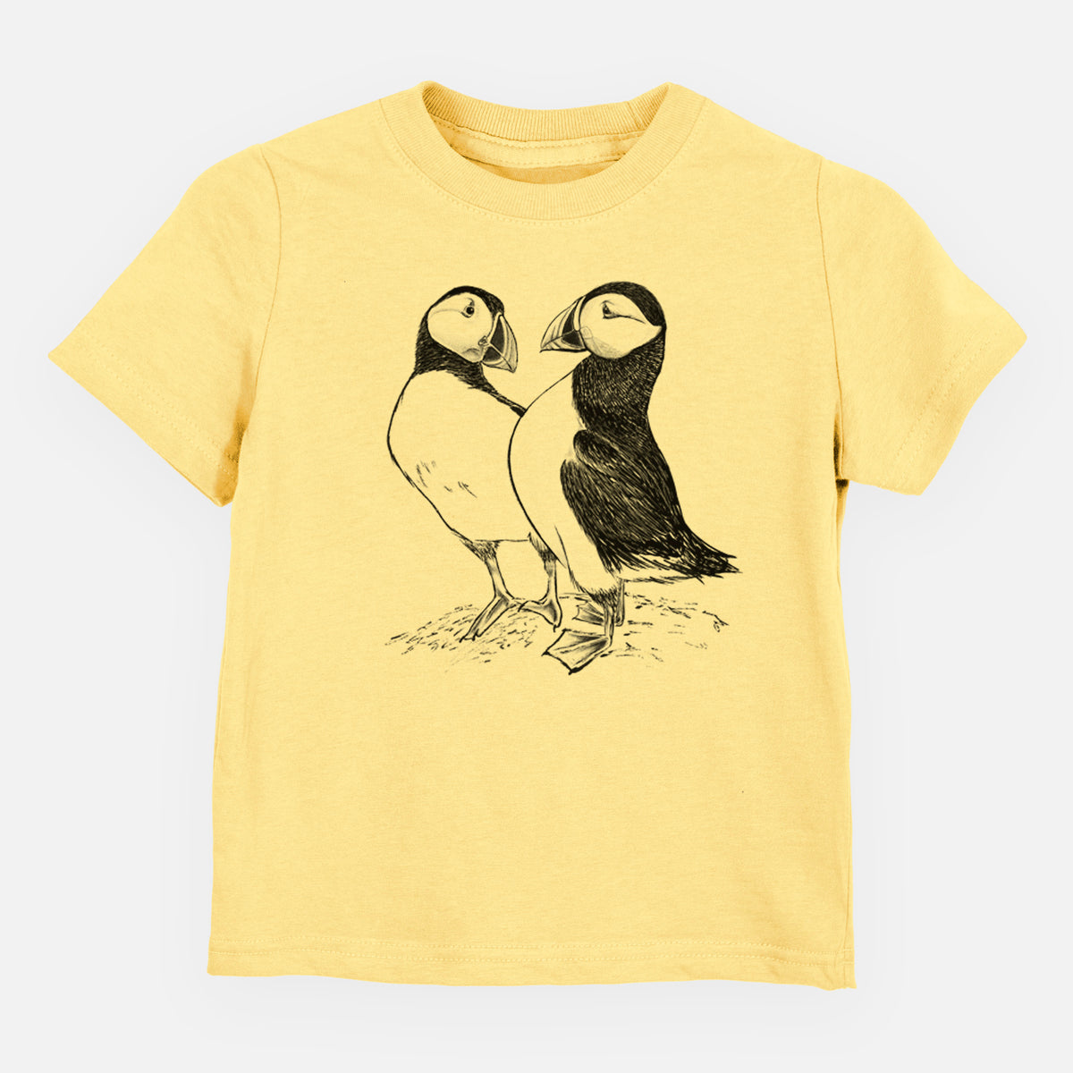 Butter yellow toddler t-shirt laid flat, printed with a detailed black ink illustration of two Atlantic puffins standing side by side.