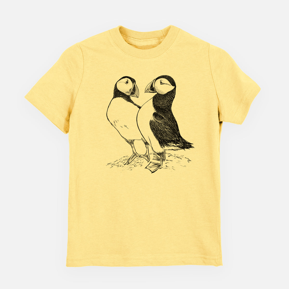 Butter yellow youth t-shirt laid flat, printed with a detailed black ink illustration of two Atlantic puffins standing side by side.