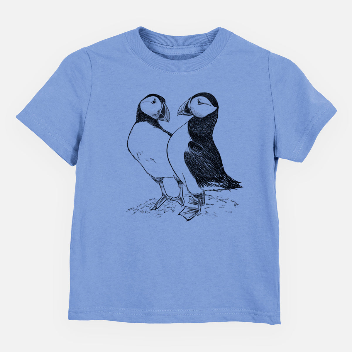 Carolina blue toddler t-shirt laid flat, printed with a detailed black ink illustration of two Atlantic puffins standing side by side.