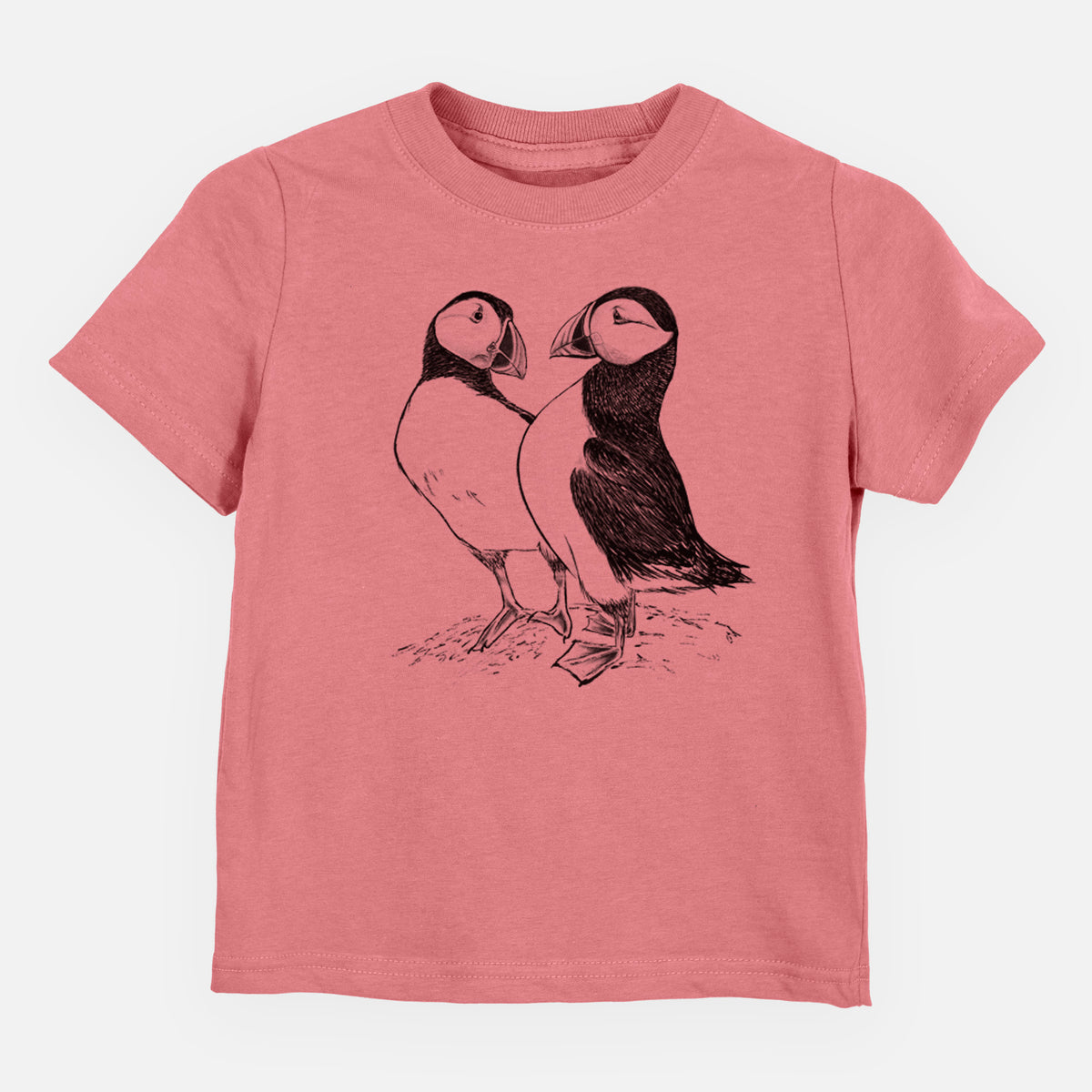 Mauve pink toddler t-shirt laid flat, printed with a detailed black ink illustration of two Atlantic puffins standing side by side.