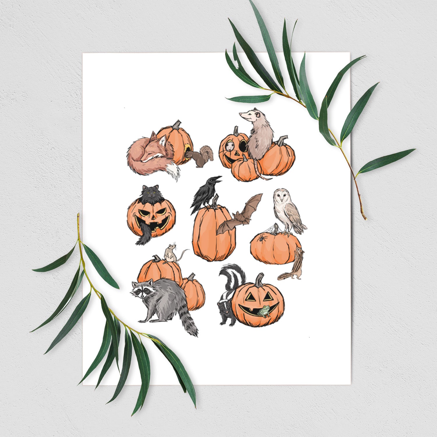 Art print of orange carved jack-o'-lanterns with black ink opossums, raccoons, owls and skunks peeking out, shown with eucalyptus leaves.