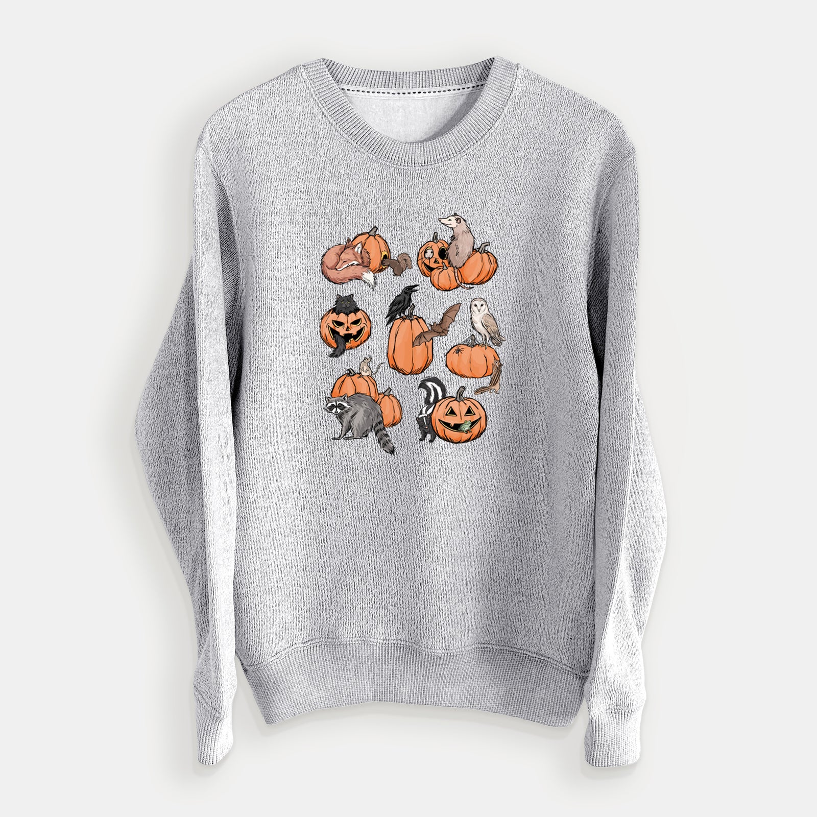 Salt and pepper knit sweatshirt laid flat, printed with orange carved jack-o'-lanterns with black ink opossums, raccoons, owls and skunks peeking out.