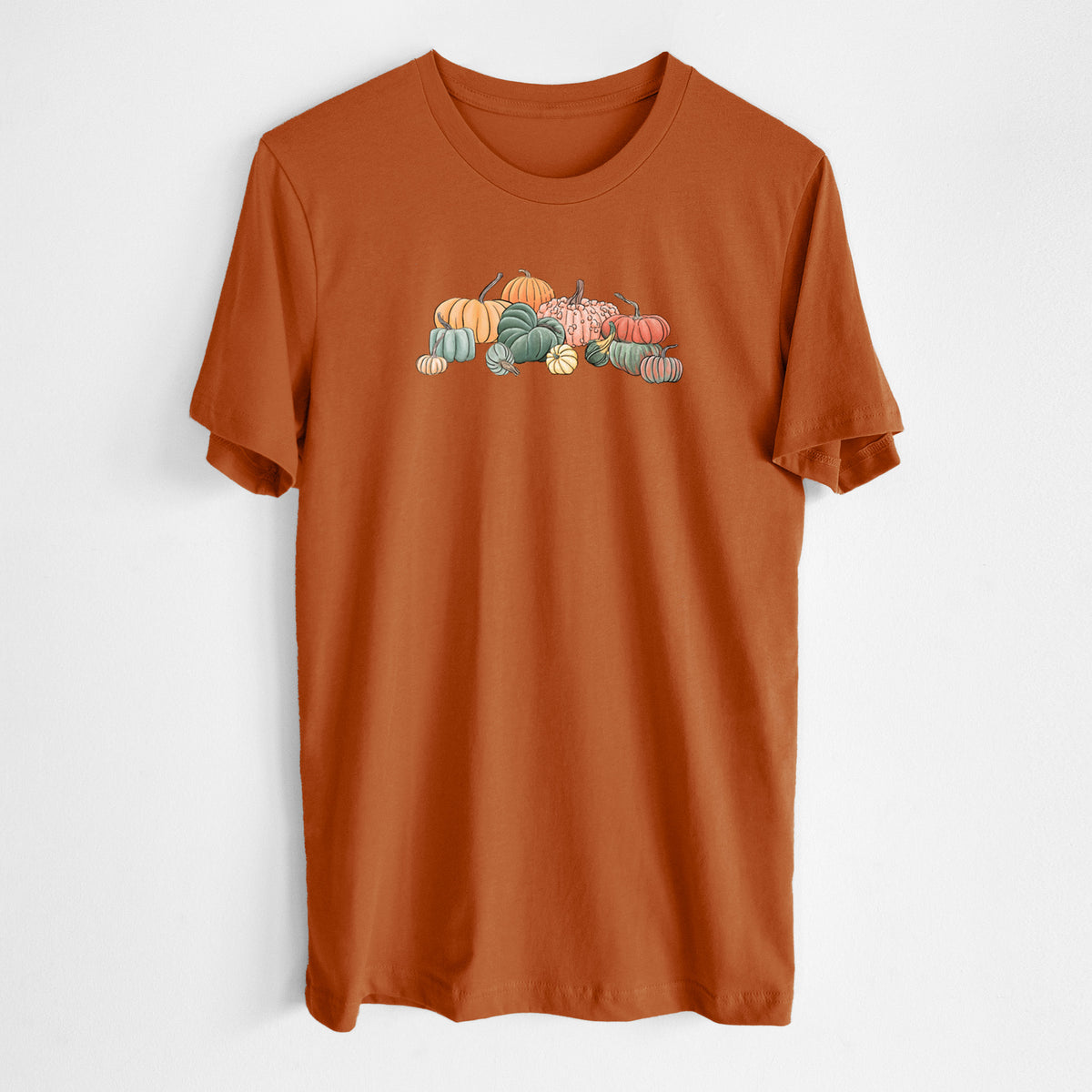 Autumn lightweight cotton t-shirt laid flat, printed with a full-color illustration of a pile of pumpkins and gourds in orange, green and white.