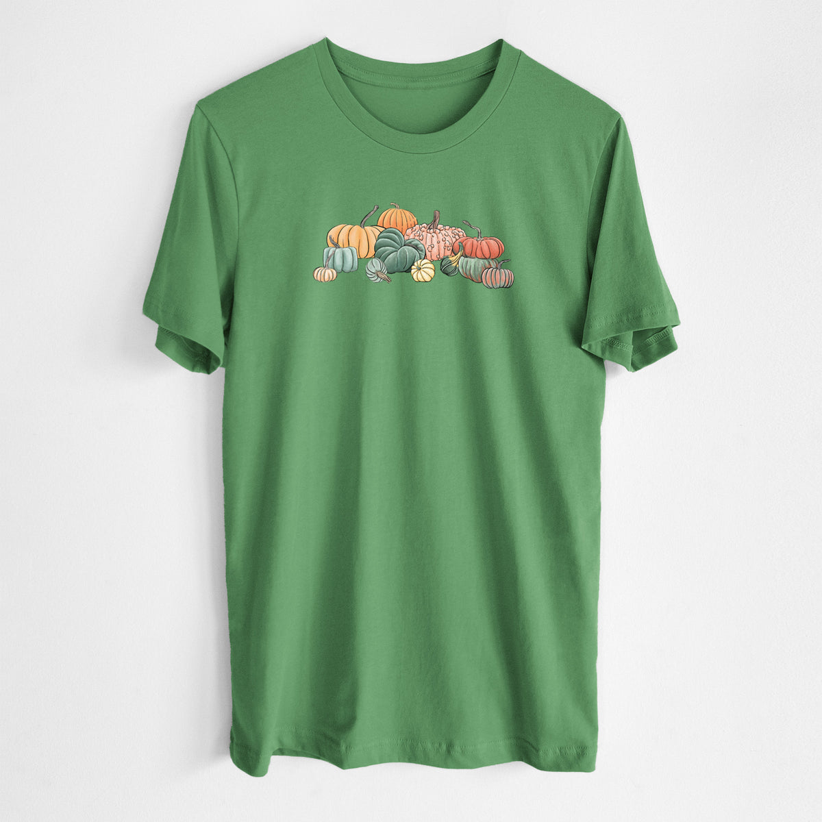 Leaf green lightweight cotton t-shirt laid flat, printed with a full-color illustration of a pile of pumpkins and gourds in orange, green and white.