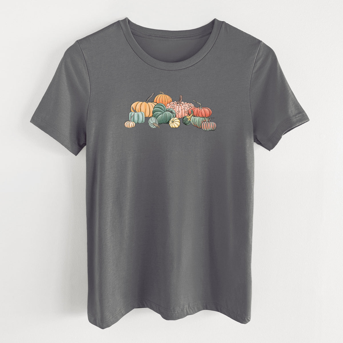 Asphalt women's relaxed fit cotton t-shirt laid flat, printed with a full-color illustration of a pile of pumpkins and gourds in orange, green and white.