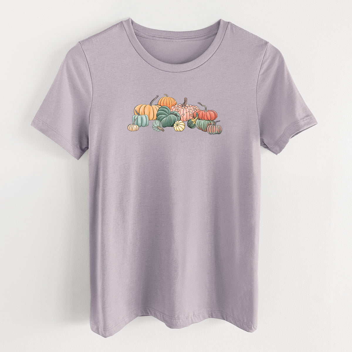 Light violet women's relaxed fit cotton t-shirt laid flat, printed with a full-color illustration of a pile of pumpkins and gourds in orange, green and white.