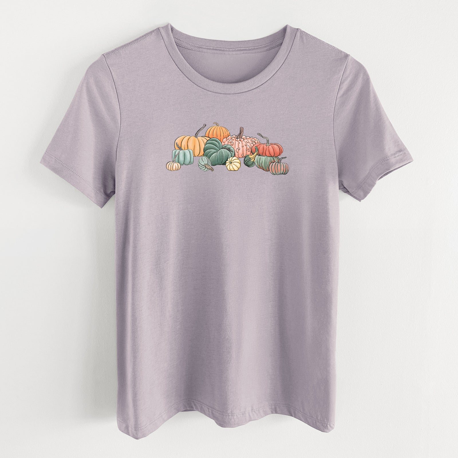 Light violet women's relaxed fit cotton t-shirt laid flat, printed with a full-color illustration of a pile of pumpkins and gourds in orange, green and white.