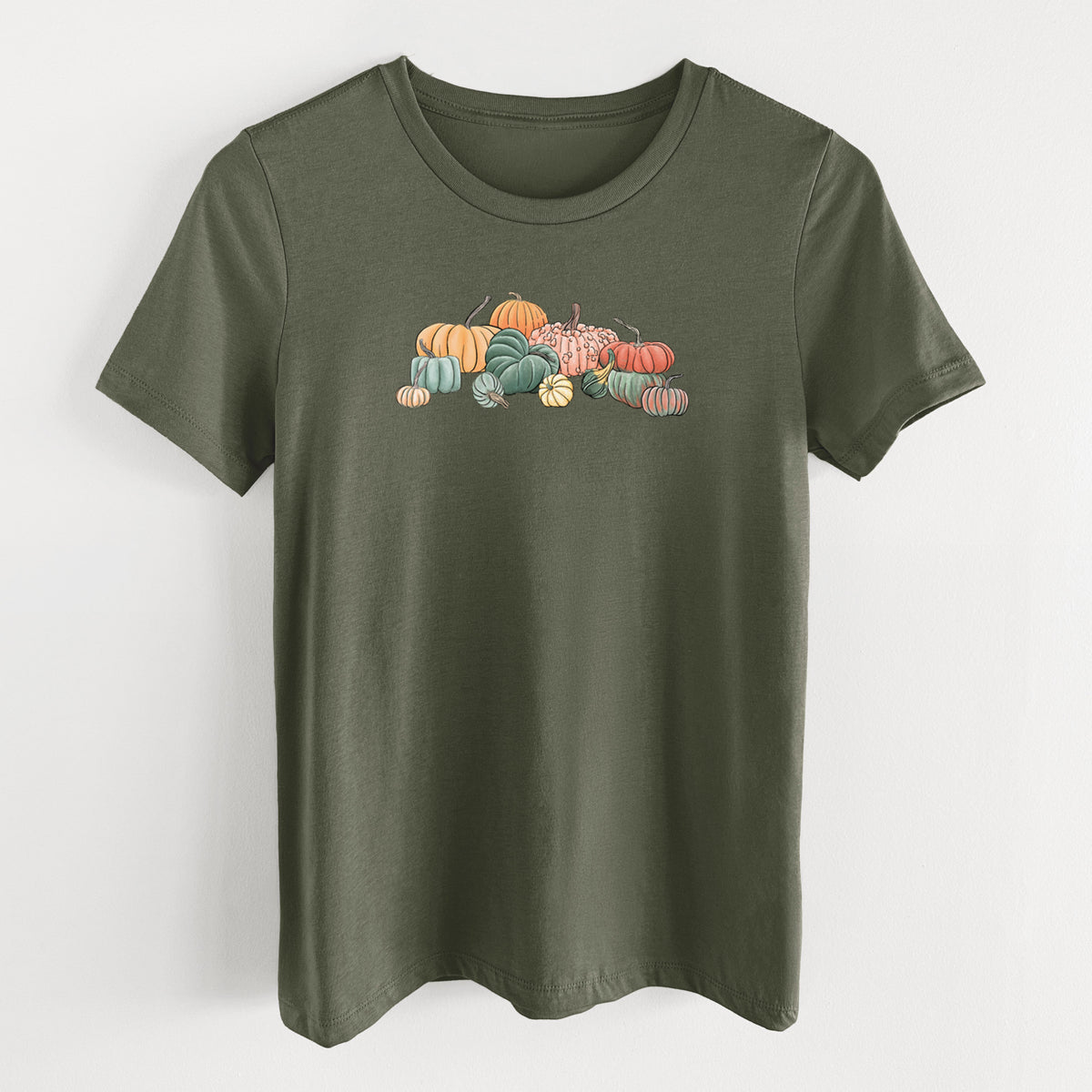 Military green women's relaxed fit cotton t-shirt laid flat, printed with a full-color illustration of a pile of pumpkins and gourds in orange, green and white.