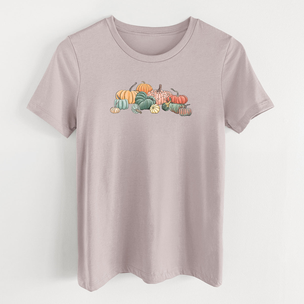 Pink gravel women's relaxed fit cotton t-shirt laid flat, printed with a full-color illustration of a pile of pumpkins and gourds in orange, green and white.