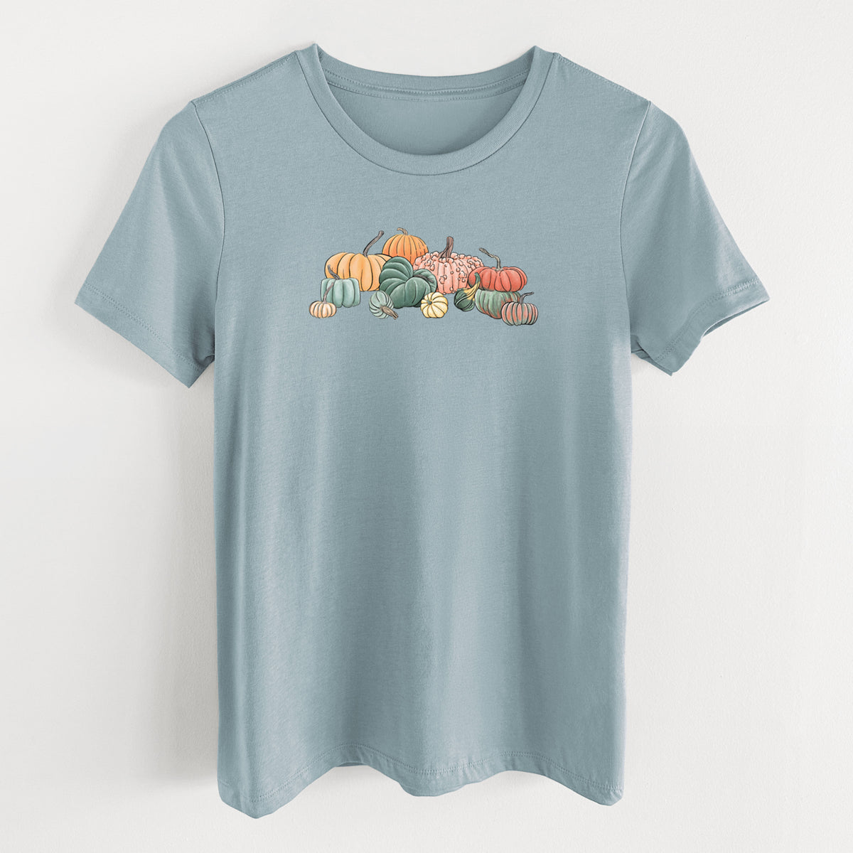 Vintage denim women's relaxed fit cotton t-shirt laid flat, printed with a full-color illustration of a pile of pumpkins and gourds in orange, green and white.
