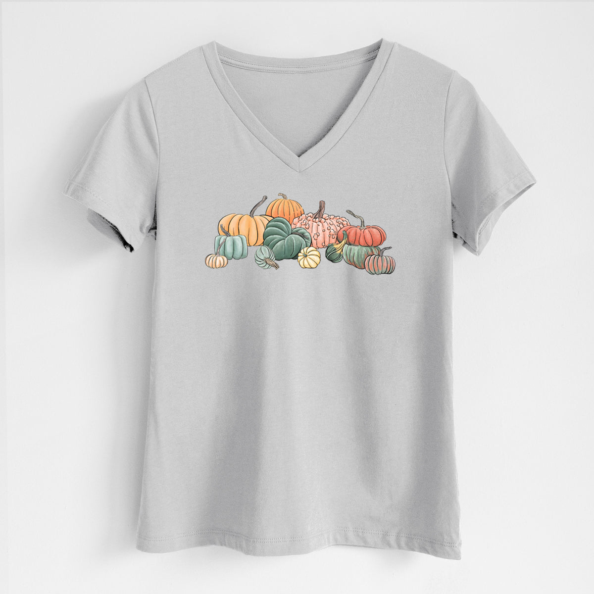 Lunar grey women's relaxed fit cotton V-neck t-shirt laid flat, printed with a full-color illustration of a pile of pumpkins and gourds in orange, green and white.