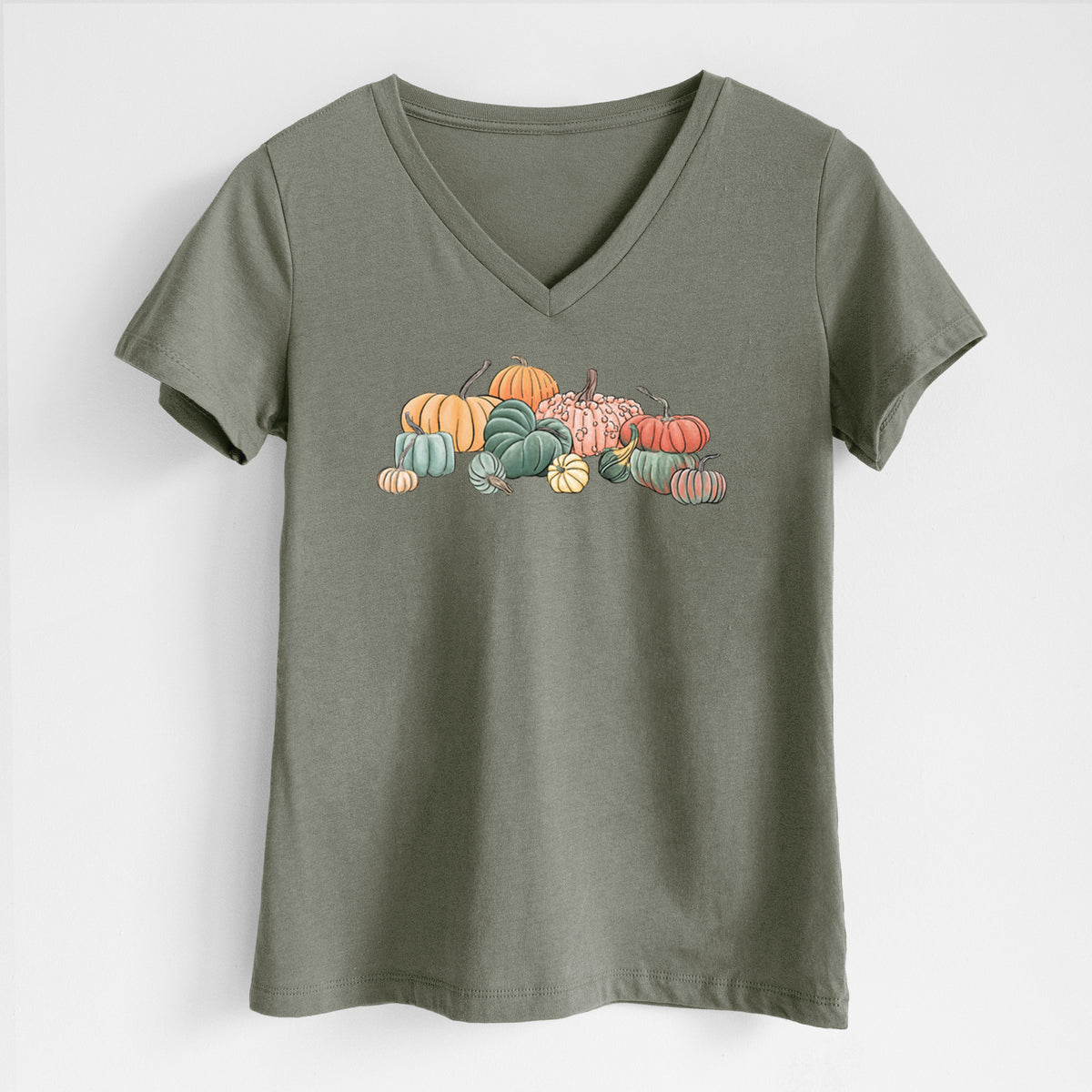 Military green women's relaxed fit cotton V-neck t-shirt laid flat, printed with a full-color illustration of a pile of pumpkins and gourds in orange, green and white.