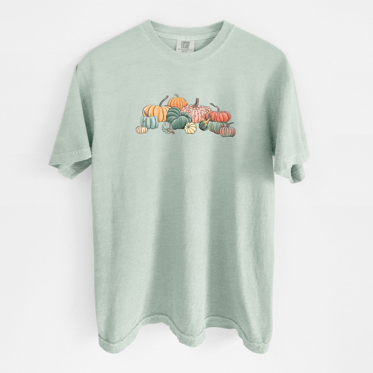 Bay green Comfort Colors t-shirt laid flat, printed with a full-color illustration of a pile of pumpkins and gourds in orange, green and white.