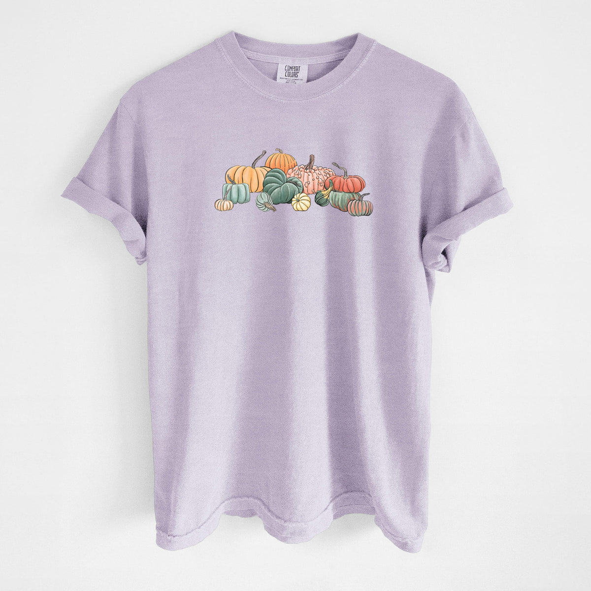 Orchid purple Comfort Colors t-shirt laid flat, printed with a full-color illustration of a pile of pumpkins and gourds in orange, green and white.