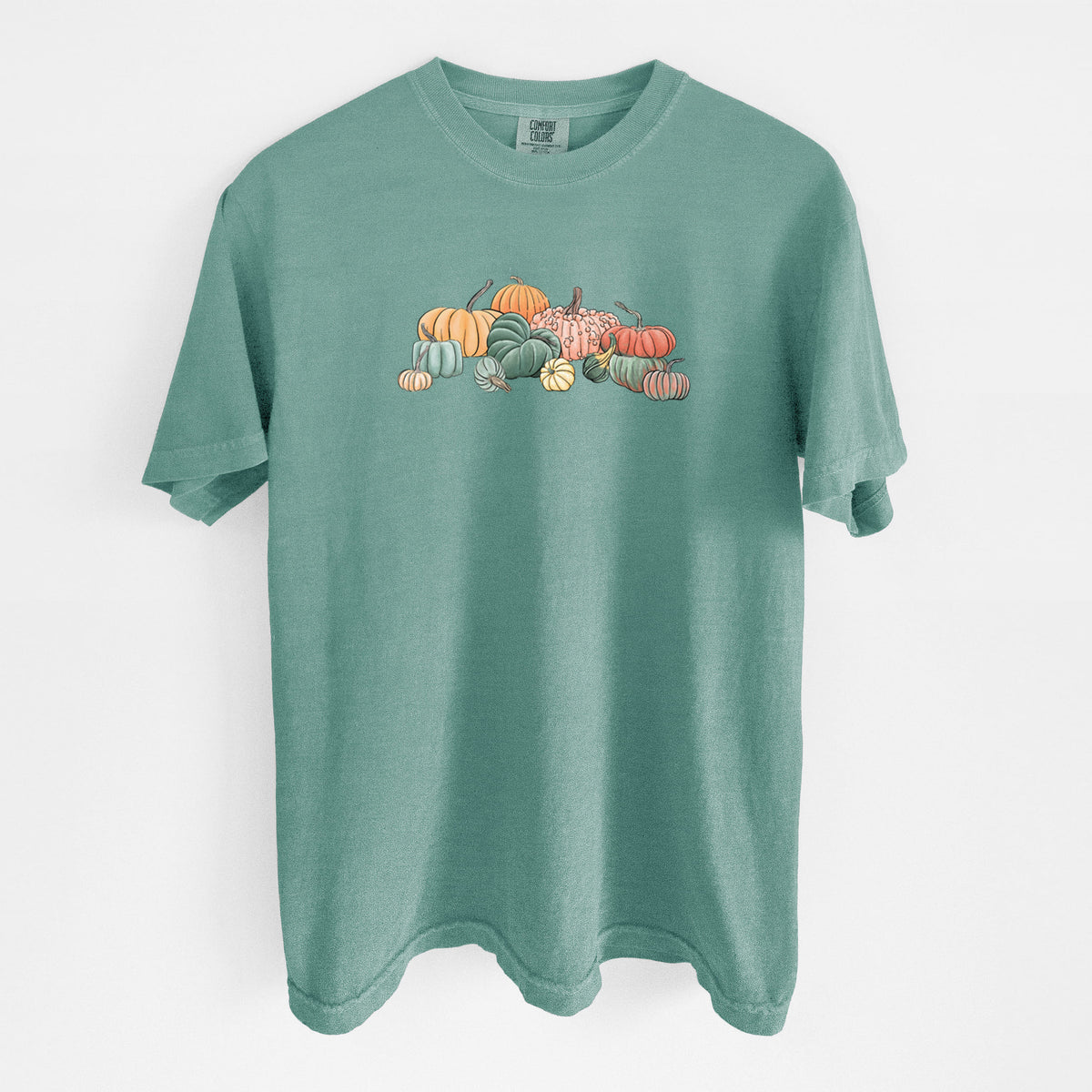 Reef green Comfort Colors t-shirt laid flat, printed with a full-color illustration of a pile of pumpkins and gourds in orange, green and white.