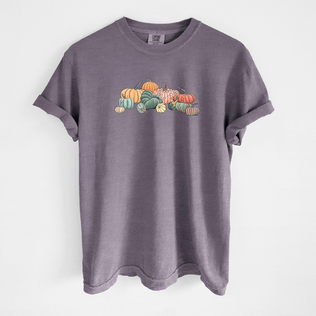 Wine red Comfort Colors t-shirt laid flat, printed with a full-color illustration of a pile of pumpkins and gourds in orange, green and white.