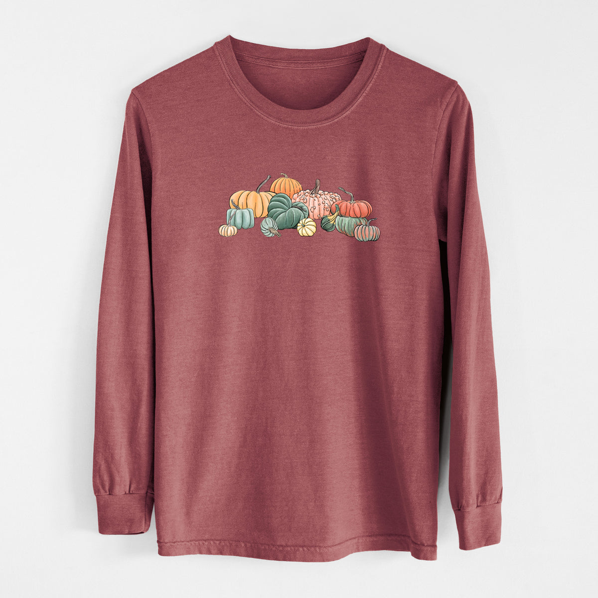 Brick red Comfort Colors long sleeve shirt laid flat, printed with a full-color illustration of a pile of pumpkins and gourds in orange, green and white.
