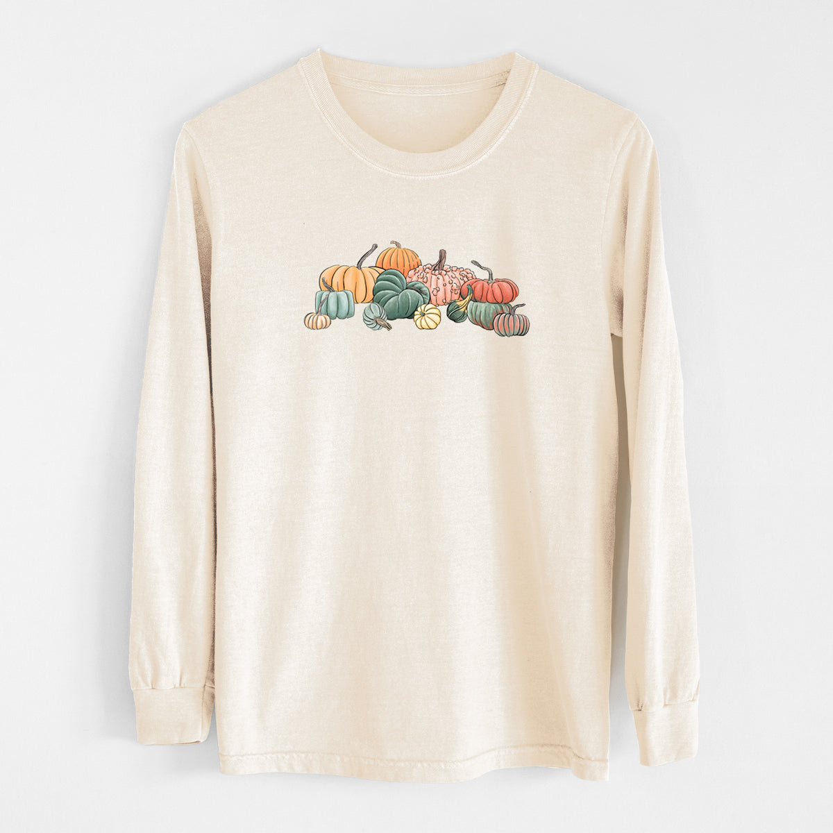 Ivory Comfort Colors long sleeve shirt laid flat, printed with a full-color illustration of a pile of pumpkins and gourds in orange, green and white.