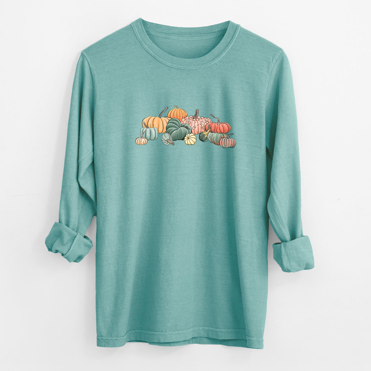 Reef green Comfort Colors long sleeve shirt laid flat with the cuffs rolled, printed with a full-color illustration of a pile of pumpkins and gourds in orange, green and white.