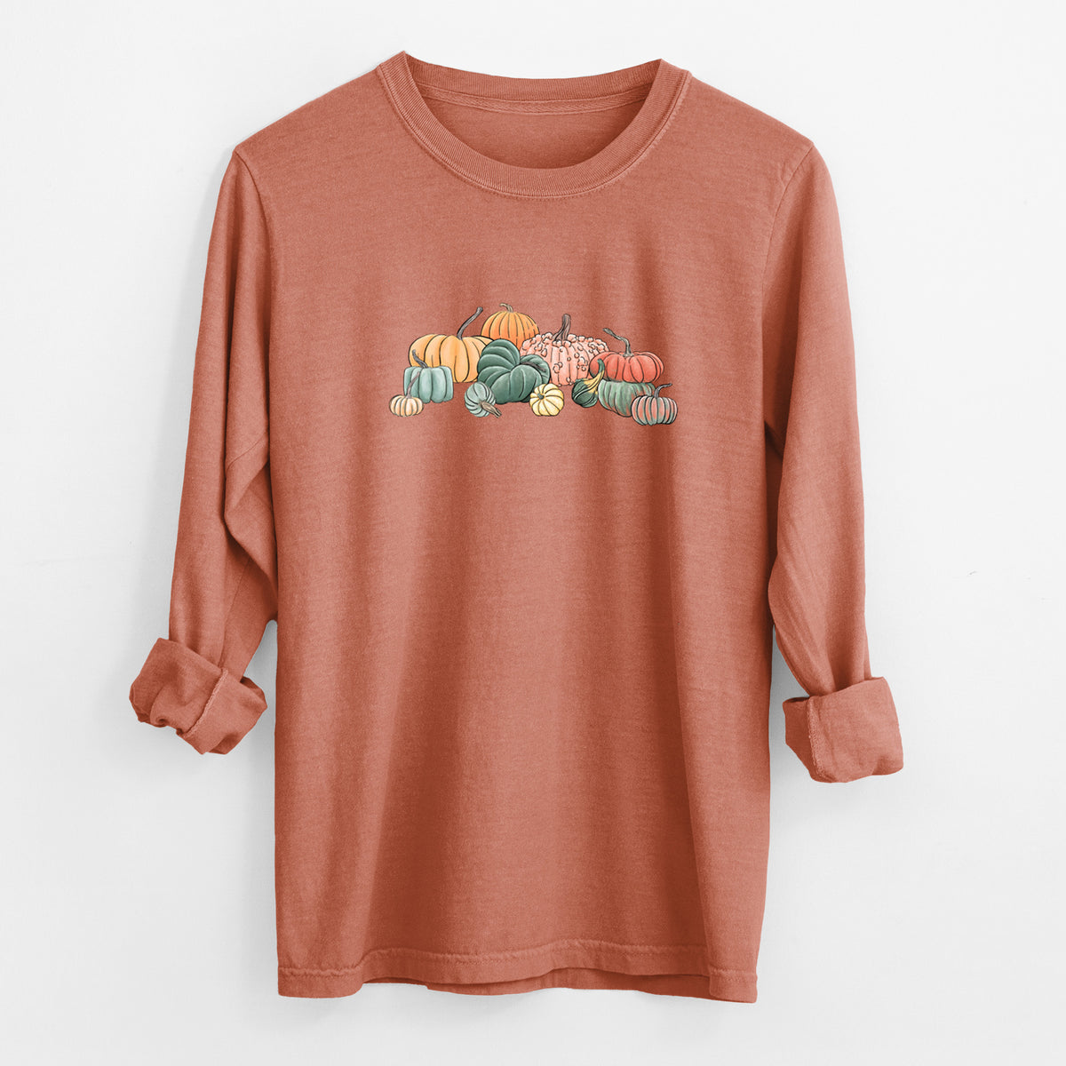 Yam burnt orange Comfort Colors long sleeve shirt laid flat with the cuffs rolled, printed with a full-color illustration of a pile of pumpkins and gourds in orange, green and white.