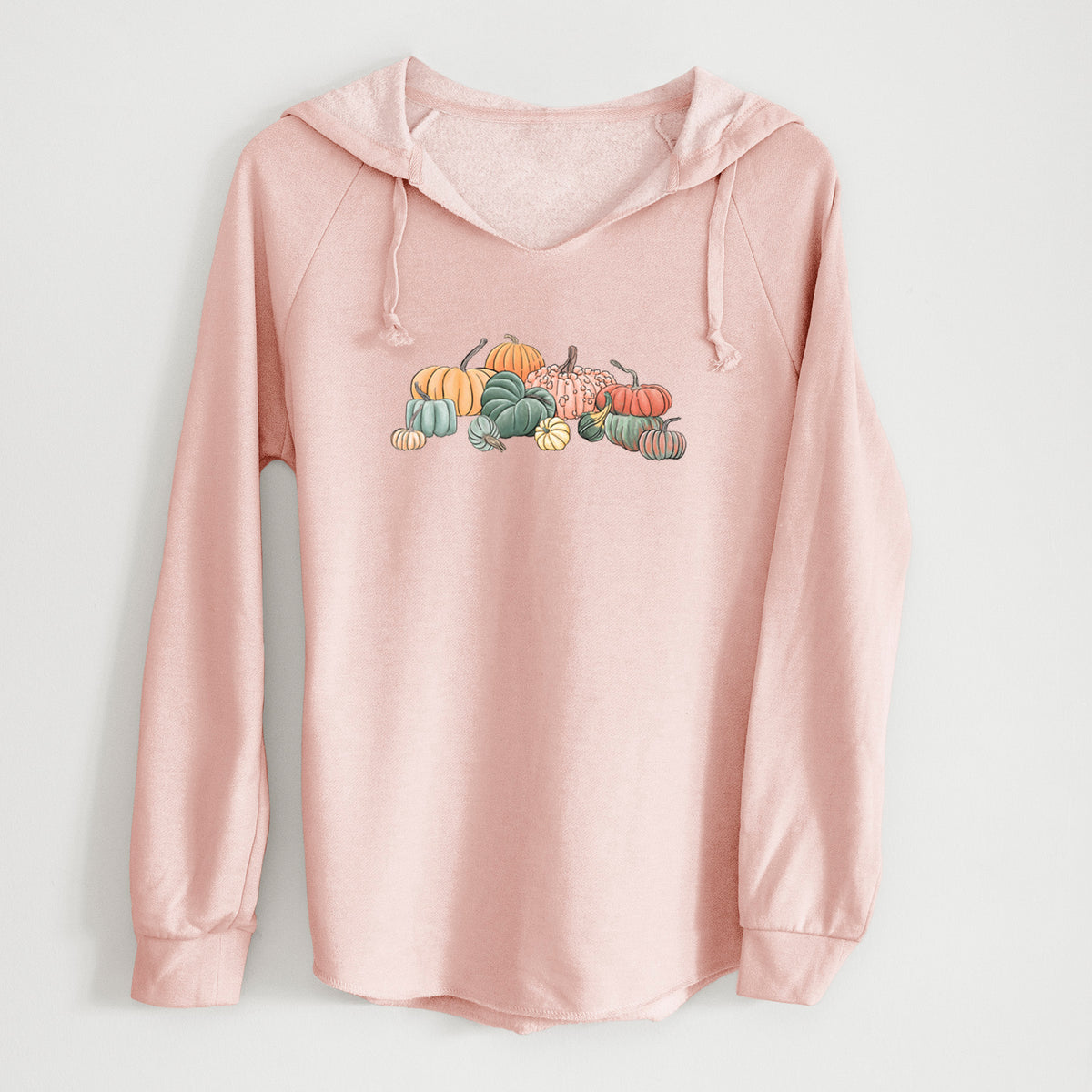Blush pink women's Cali Wave hooded sweatshirt laid flat, printed with a full-color illustration of a pile of pumpkins and gourds in orange, green and white.