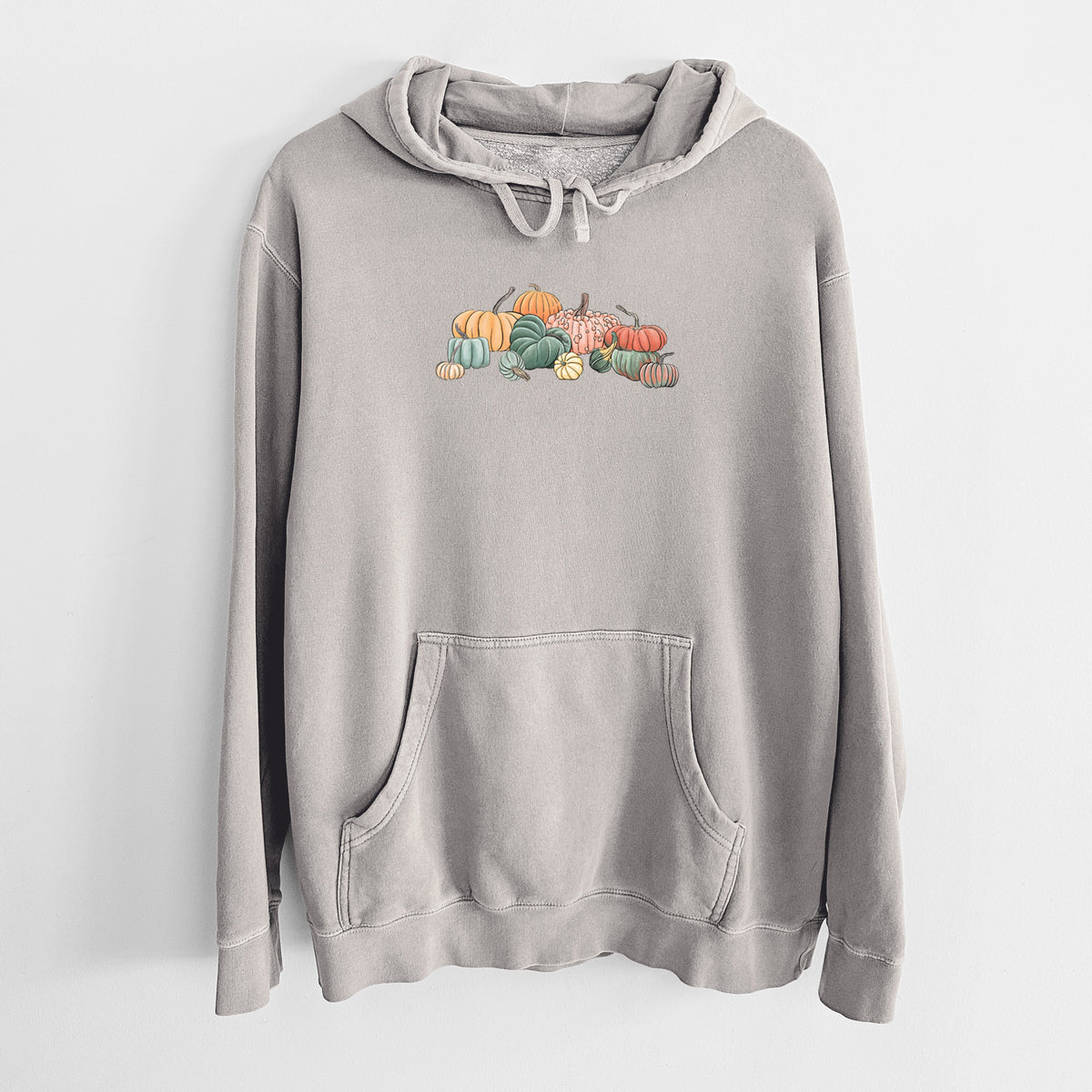 Cement grey pigment dyed hoodie laid flat, printed with a full-color illustration of a pile of pumpkins and gourds in orange, green and white.