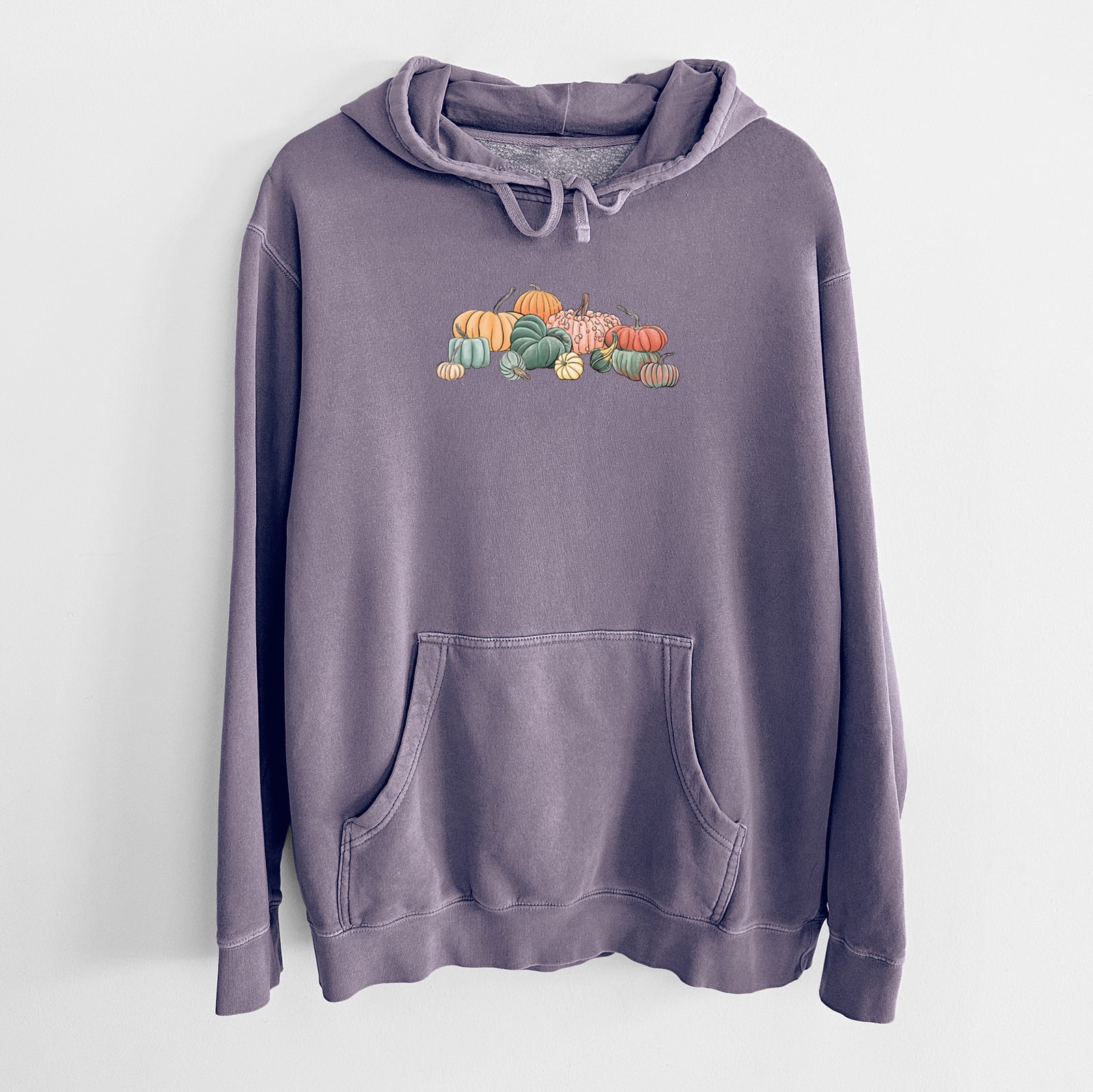 Plum purple pigment dyed hoodie laid flat, printed with a full-color illustration of a pile of pumpkins and gourds in orange, green and white.