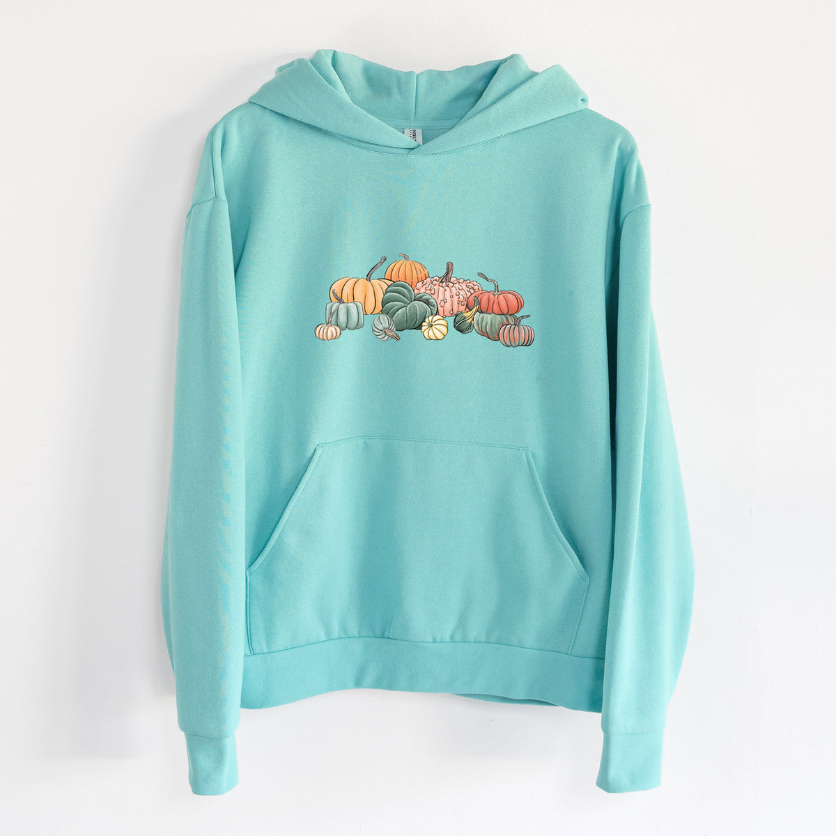 Pumpkin Harvest - Statement Midweight Hoodie in Seafoam, hanging on a white wall, with a front kangaroo pocket and no drawcords.