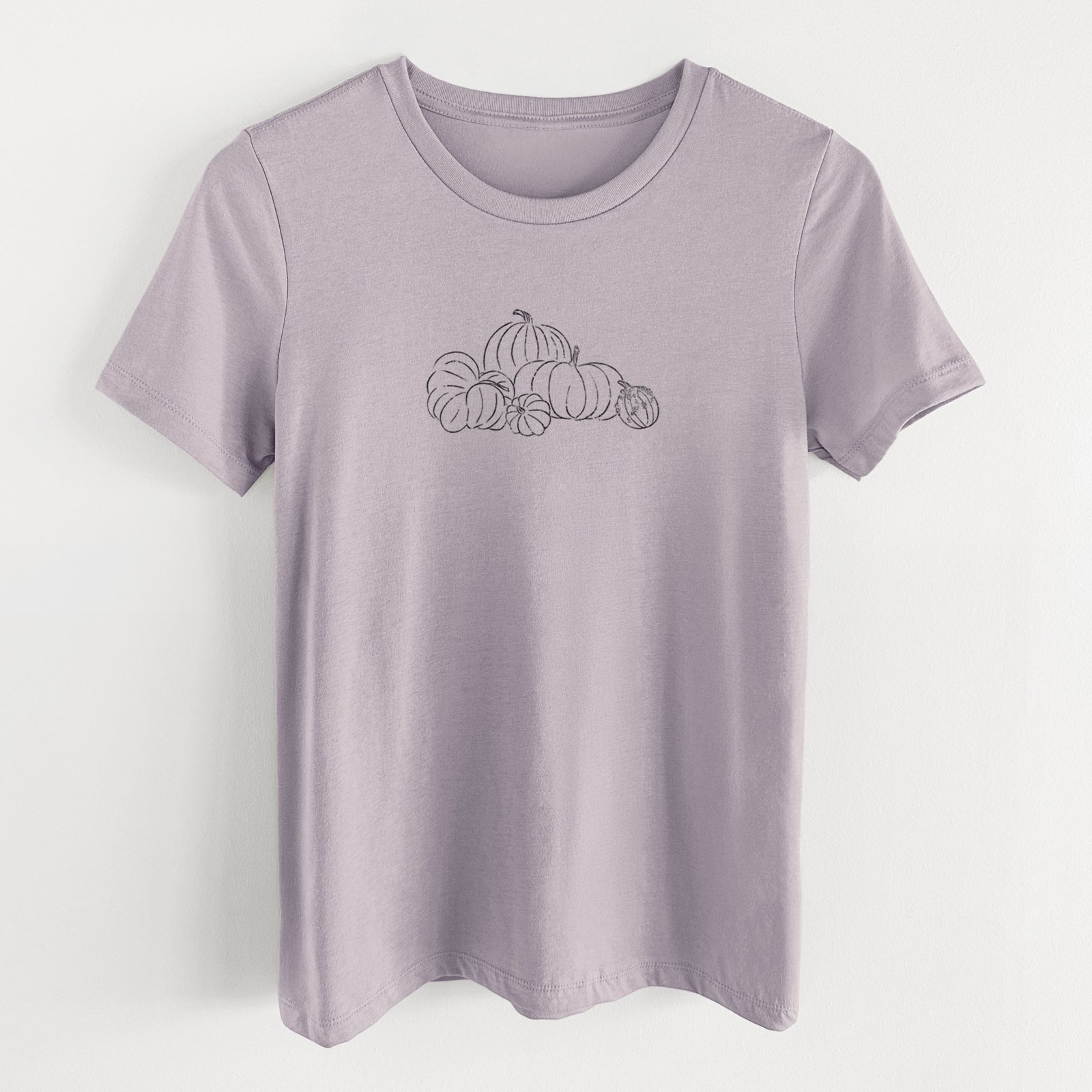 Light violet women's relaxed fit cotton t-shirt laid flat, printed with a black ink line drawing of a pile of pumpkins.