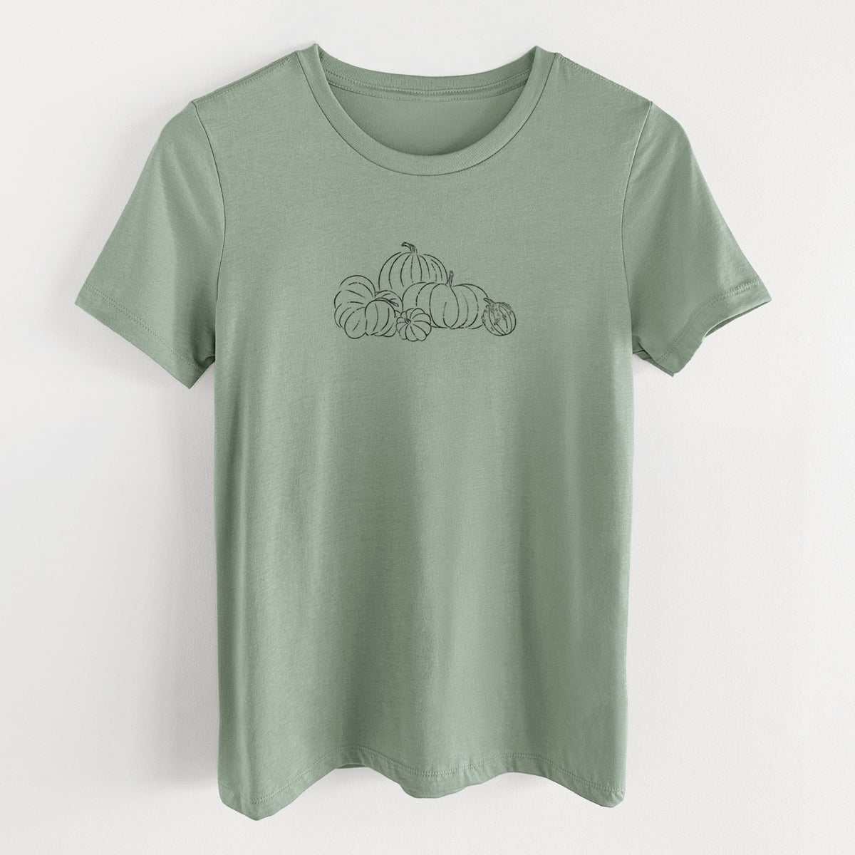 Sage green women's relaxed fit cotton t-shirt laid flat, printed with a black ink line drawing of a pile of pumpkins.